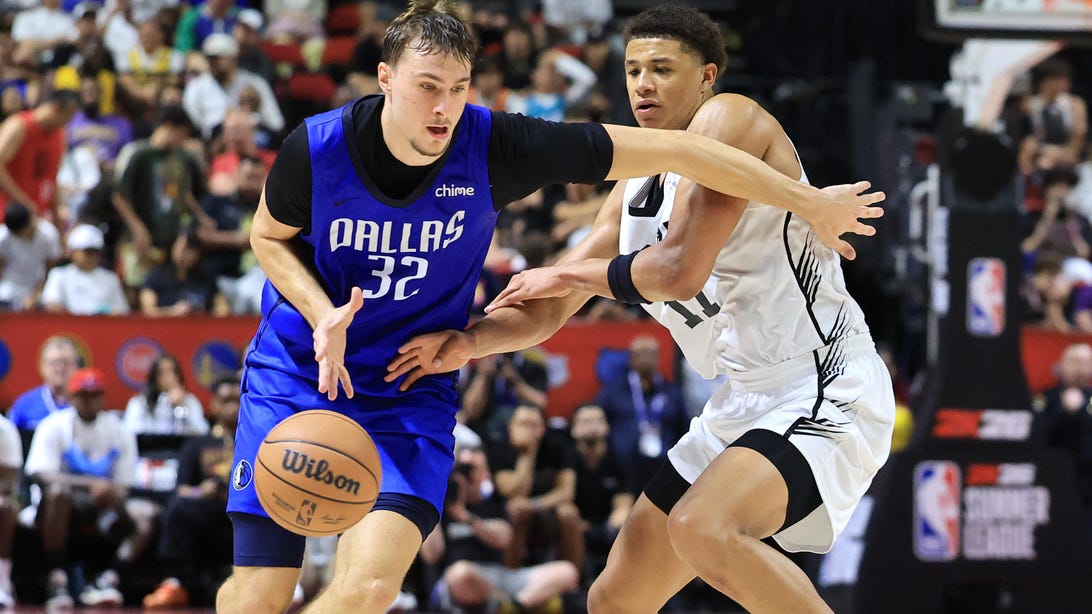 LAS VEGAS, NEVADA - JULY 12: Cooper Flagg #32 of the Dallas Mavericks is fouled by Carter Bryant #11 of the San Antonio Spurs in the second half of a 2025 NBA Summer League game at the Thomas & Mack Center on July 12, 2025 in Las Vegas, Nevada.