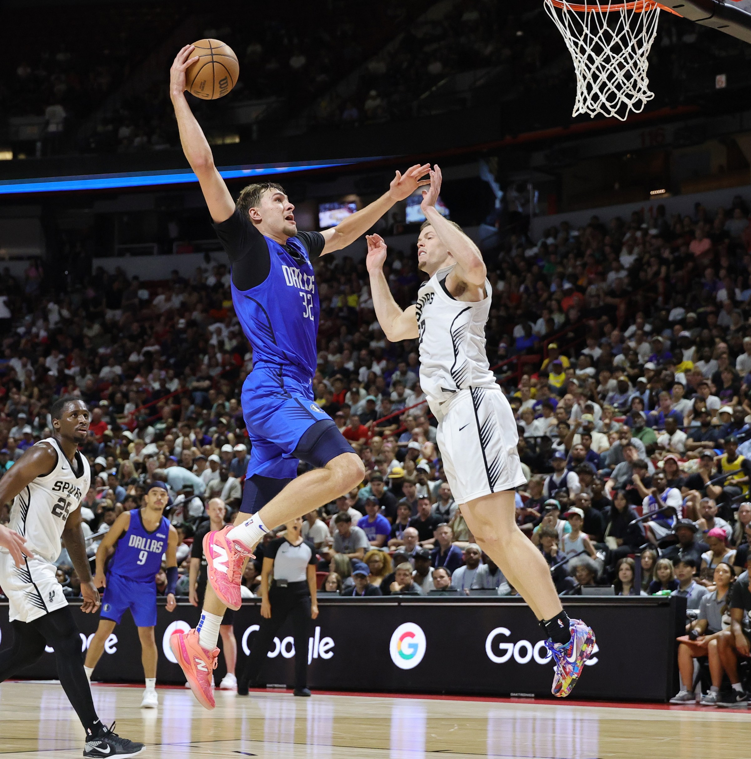 LAS VEGAS, NEVADA - JULY 12: Cooper Flagg #32 of the Dallas Mavericks dunks against Riley Minix #27 of the San Antonio Spurs in the second half of a 2025 NBA Summer League game at the Thomas & Mack Center on July 12, 2025 in Las Vegas, Nevada. NOTE TO USER: User expressly acknowledges and agrees that, by downloading and or using this photograph, User is consenting to the terms and conditions of the Getty Images License Agreement. (Photo by Ethan Miller/Getty Images)