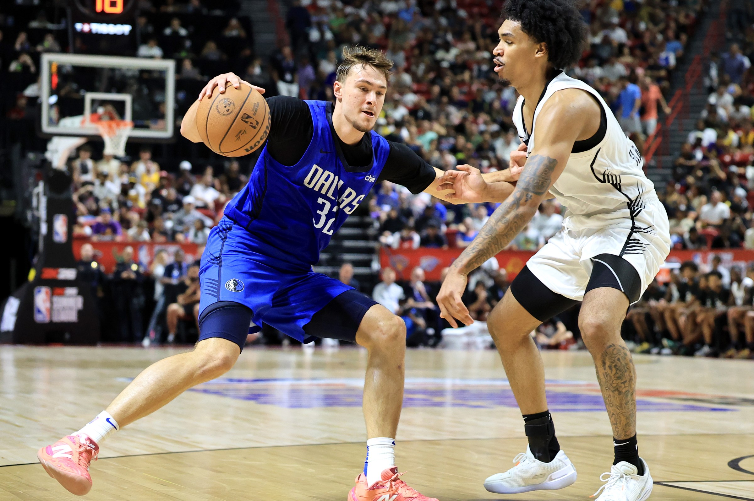 LAS VEGAS, NEVADA - JULY 12: Cooper Flagg #32 of the Dallas Mavericks drives against Dylan Harper #2 of the San Antonio Spurs in the second half of a 2025 NBA Summer League game at the Thomas & Mack Center on July 12, 2025 in Las Vegas, Nevada. NOTE TO USER: User expressly acknowledges and agrees that, by downloading and or using this photograph, User is consenting to the terms and conditions of the Getty Images License Agreement. (Photo by Ethan Miller/Getty Images)
