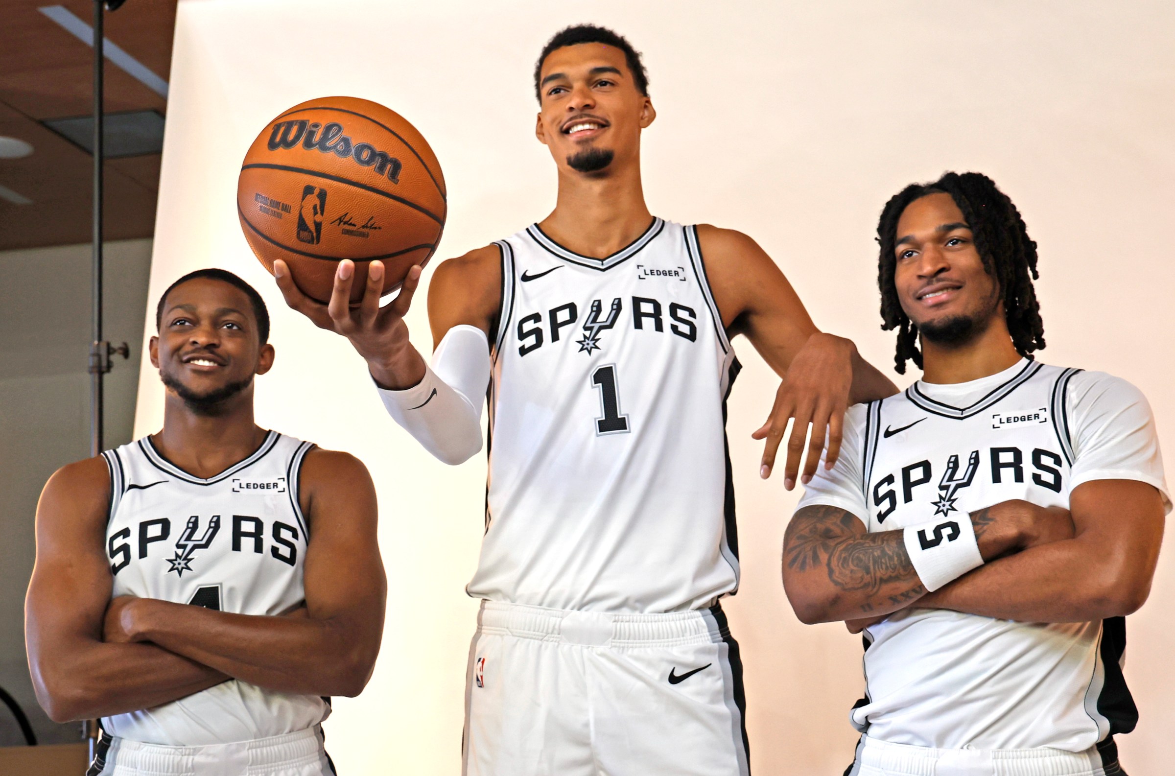 SAN ANTONIO, TX - SEPTEMBER 29: De’Aaron Fox #4 of the San Antonio Spurs,Victor Wembanyama #1, and Stephon Castle #5 pose for photographs at San Antonio Spurs Media Day at Victory Capital Performance Center on September 29, 2025 in San Antonio, Texas. NOTE TO USER: User expressly acknowledges and agrees that, by downloading and or using this photograph, User is consenting to terms and conditions of the Getty Images License Agreement. (Photo by Ronald Cortes/Getty Images)