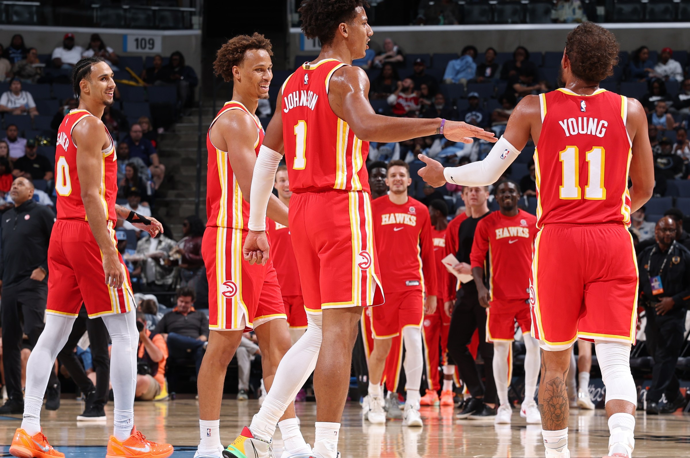 MEMPHIS, TN - OCTOBER 11: Jalen Johnson #1 of the Atlanta Hawks high fives Trae Young #11 of the Atlanta Hawks during the game against the Memphis Grizzlies during Preseason on October 11, 2025 at FedExForum in Memphis, Tennessee. NOTE TO USER: User expressly acknowledges and agrees that, by downloading and or using this photograph, User is consenting to the terms and conditions of the Getty Images License Agreement. Mandatory Copyright Notice: Copyright 2025 NBAE (Photo by Joe Murphy/NBAE via Getty Images)