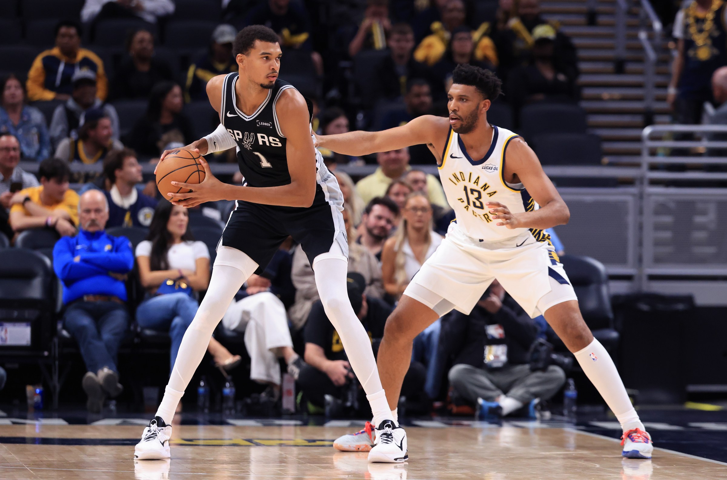 INDIANAPOLIS, INDIANA - OCTOBER 13: Victor Wembanyama #1 of the San Antonio Spurs makes a move on Tony Bradley #13 of the Indiana Pacers in the fourth quarter of the preseason game at Bankers Life Fieldhouse on October 13, 2025 in Indianapolis, Indiana. NOTE TO USER: User expressly acknowledges and agrees that, by downloading and or using this photograph, User is consenting to the terms and conditions of the Getty Images License Agreement. (Photo by Justin Casterline/Getty Images)
