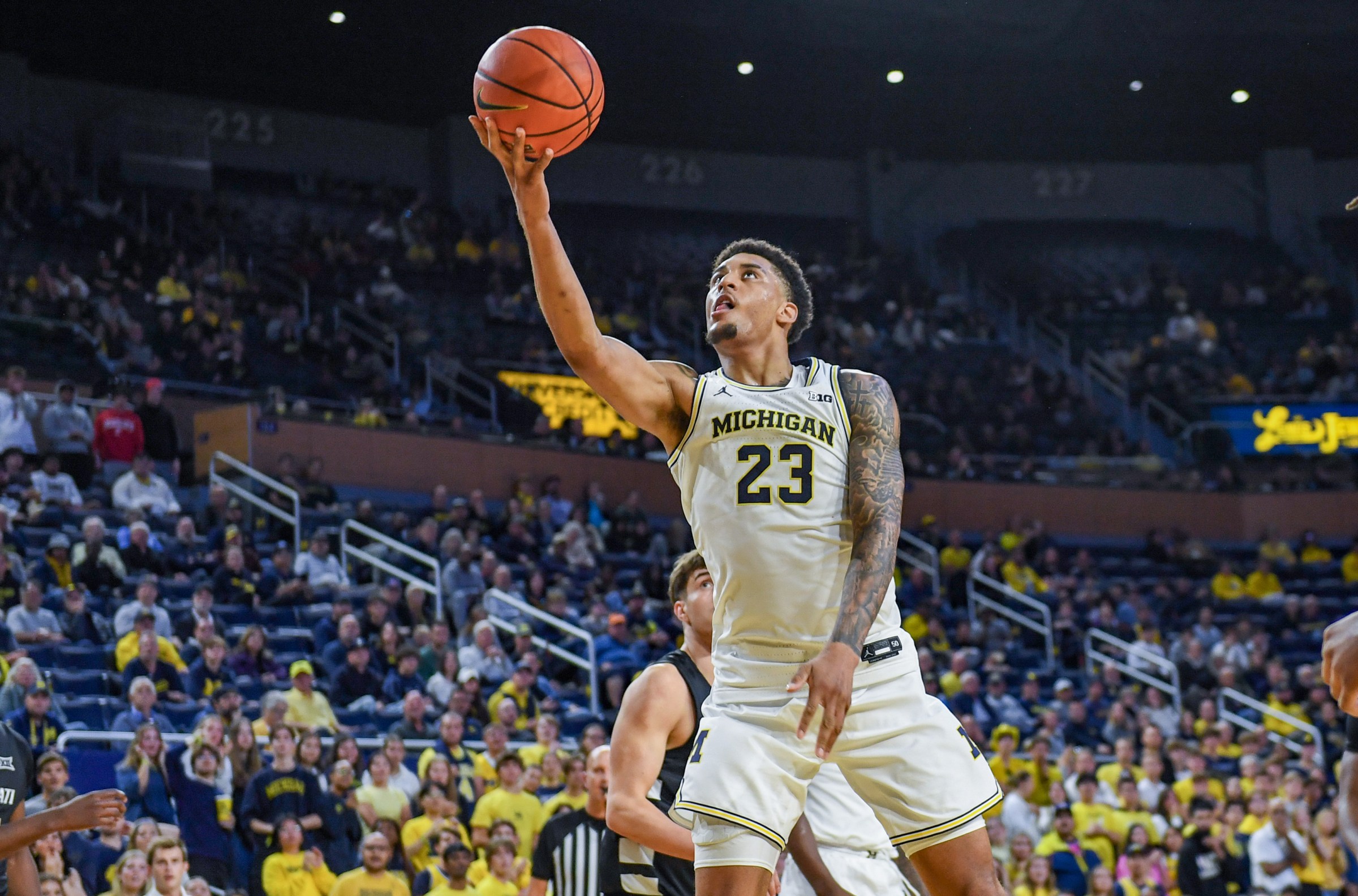 ANN ARBOR, MICHIGAN - OCTOBER 17: Yaxel Lendeborg #23 of the Michigan Wolverines attempts a layup in front of a defender during the second half of the college basketball exhibition game against the Cincinnati Bearcats at Crisler Arena on October 17, 2025 in Ann Arbor, Michigan. The Cincinnati Bearcats won the game 100-98. (Photo by Aaron J. Thornton/Getty Images)