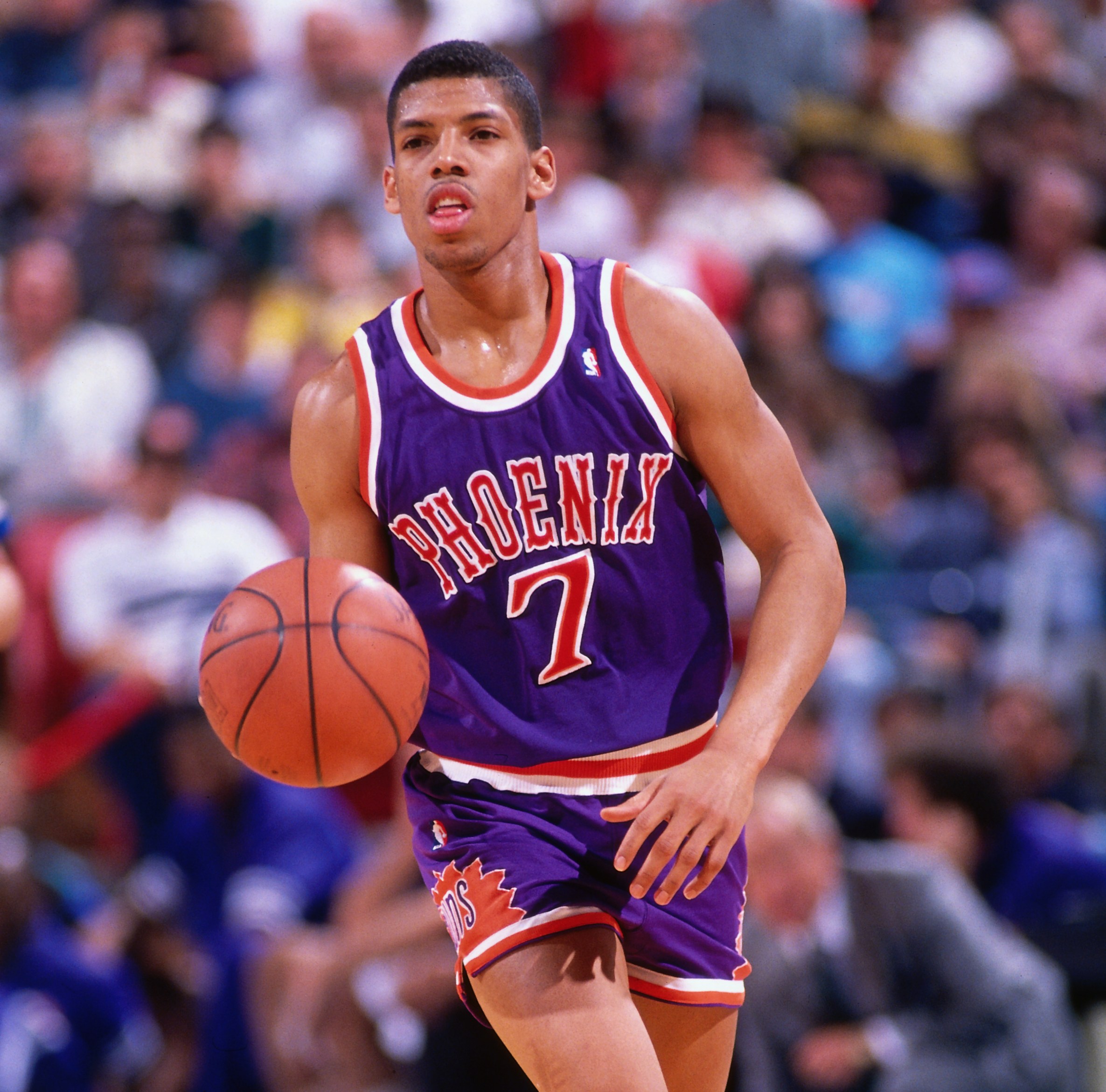 SACRAMENTO, CA - 1990: Kevin Johnson #7 of the Phoenix Suns dribbles against the Sacramento Kings circa 1990 at Arco Arena in Sacramento, California. NOTE TO USER: User expressly acknowledges and agrees that, by downloading and or using this photograph, User is consenting to the terms and conditions of the Getty Images License Agreement. Mandatory Copyright Notice: Copyright 1990 NBAE (Photo by Rocky Widner/NBAE via Getty Images)