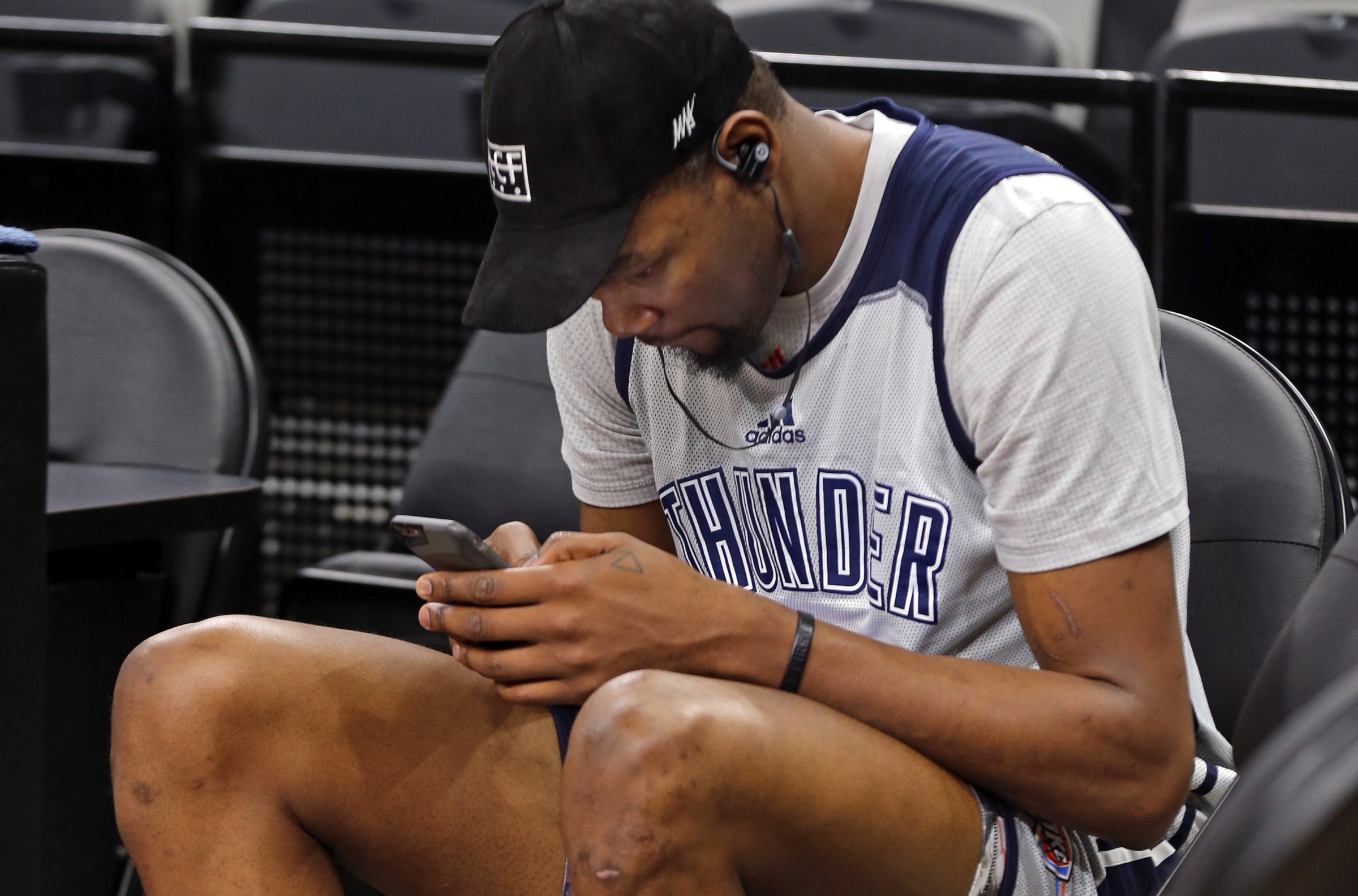 SAN ANTONIO, TX - MAY 10: Kevin Durant #35 of the Oklahoma City Thunder texts on his phone during a practice before Game Five of the NBA Western Conference Semi-finals against the San Antonio Spurs on May 10, 2016 at the AT&T Center in San Antonio, Texas. NOTE TO USER: User expressly acknowledges and agrees that, by downloading and or using this Photograph, user is consenting to the terms and conditions of the Getty Images License Agreement. Mandatory Copyright Notice: Copyright 2016 NBAE (Photo by Layne Murdoch/NBAE via Getty Images)