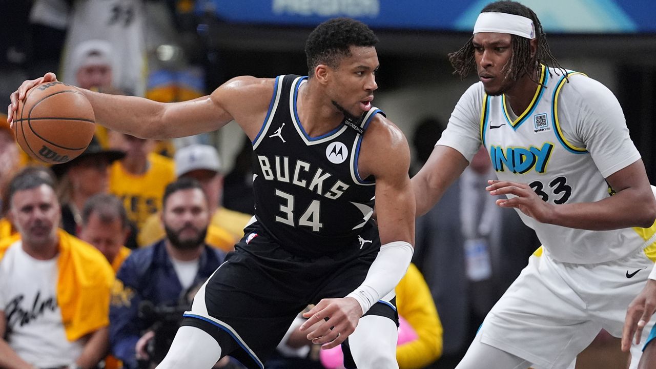Milwaukee Bucks forward Giannis Antetokounmpo (34) dribbles the ball against Indiana Pacers center Myles Turner (33) during the second half in Game 5 of an NBA basketball first-round playoff series in Indianapolis, Tuesday, April 29, 2025.