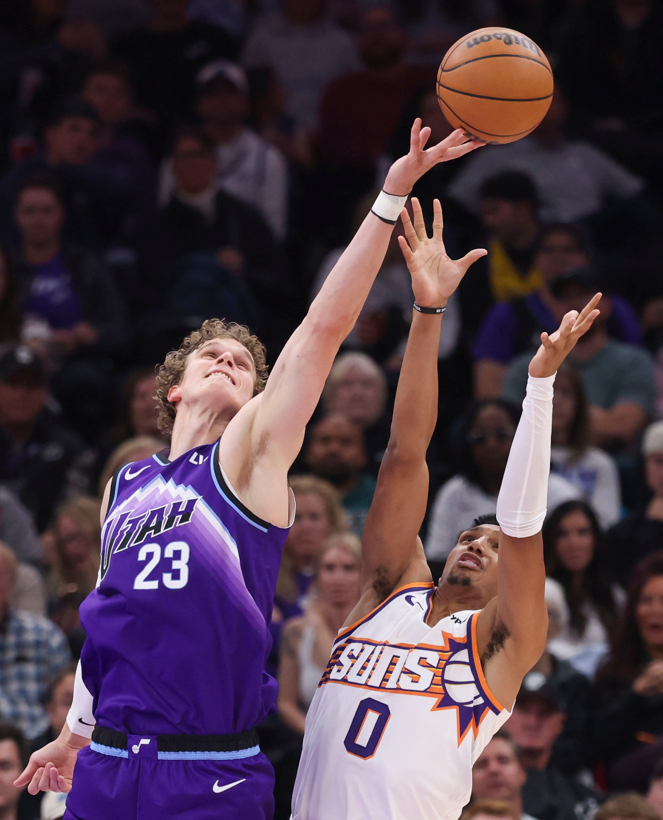 Oct 27, 2025; Salt Lake City, Utah, USA; Utah Jazz forward Lauri Markkanen (23) and Phoenix Suns forward Ryan Dunn (0) battle for a rebound during the second half at Delta Center. Mandatory Credit: Rob Gray-Imagn Images