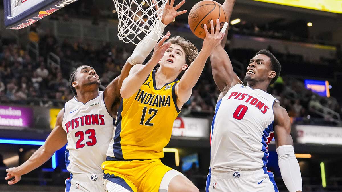 Indiana Pacers forward Johnny Furphy (12) goes up for a shot against Detroit Pistons guard Jaden Ivey (23) and Detroit Pistons center Jalen Duren (0) on Friday, Nov. 29, 2024, during a game between the Indiana Pacers and the Detroit Pistons at Gainbridge Fieldhouse in Indianapolis.