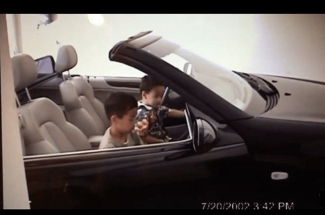 Johnny Juzang and older brother Christian Juzang sitting in a car as young children