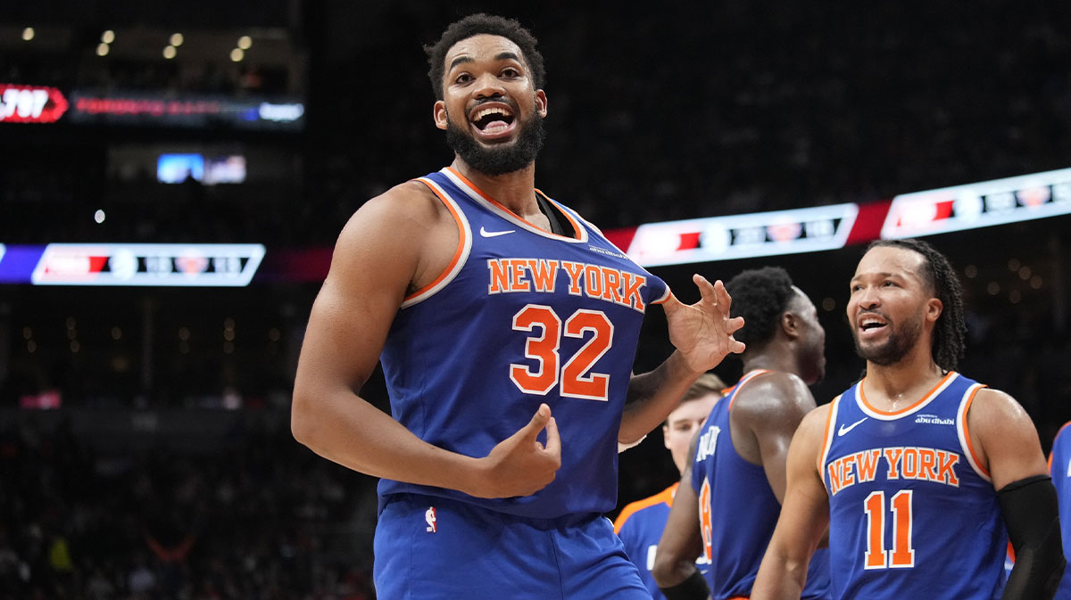 Dec 9, 2024; Toronto, Ontario, CAN; New York Knicks guard Jalen Brunson (11) watches as center Karl-Anthony Towns (32) celebrates after making a three point basket to clinch a win against the Toronto Raptors near the end of the fourth quarter at Scotiabank Arena. Mandatory Credit: John E. Sokolowski-Imagn Images