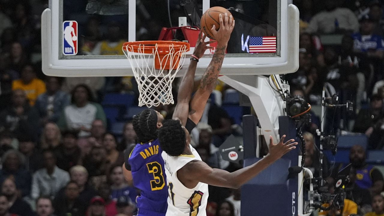 Los Angeles Lakers forward Anthony Davis (3) and New Orleans Pelicans center Yves Missi battle under the basket in the first half of an NBA basketball game in New Orleans, Saturday, Nov. 16, 2024. (AP Photo/Gerald Herbert)
