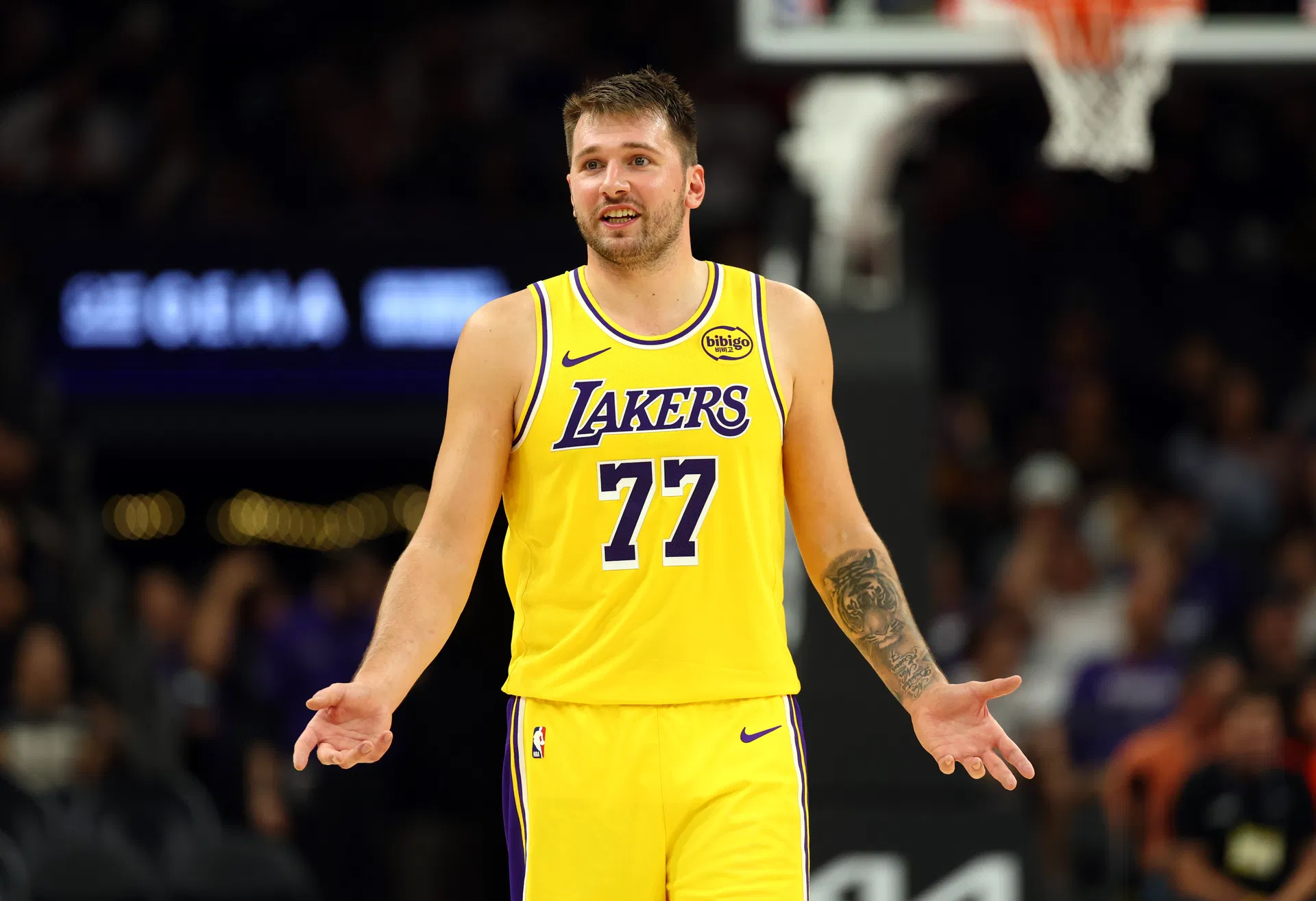 Oct 14, 2025; Phoenix, Arizona, USA; Los Angeles Lakers guard Luka Doncic (77) against the Phoenix Suns during an NBA preseason game at Mortgage Matchup Center. Mandatory Credit: Mark J. Rebilas-Imagn Images