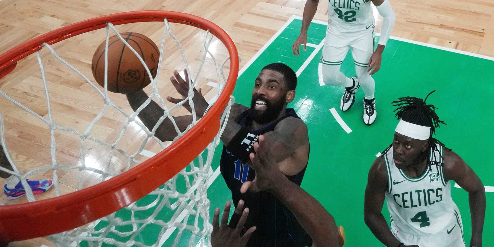 Kyrie Irving being defended by Jrue Holiday