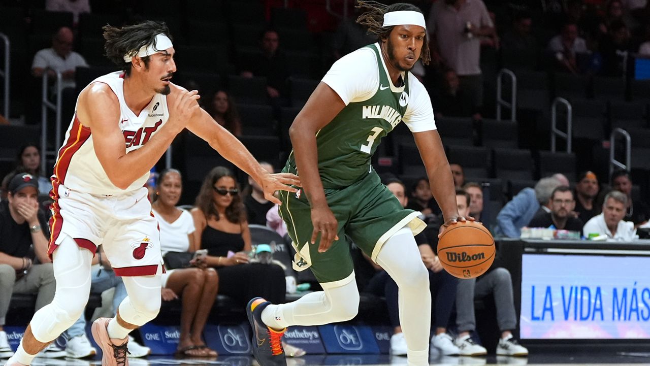 Milwaukee Bucks center Myles Turner (3) drives past Miami Heat guard Jaime Jaquez Jr. during the first half of a preseason NBA basketball game, Monday, Oct. 6, 2025, in Miami.