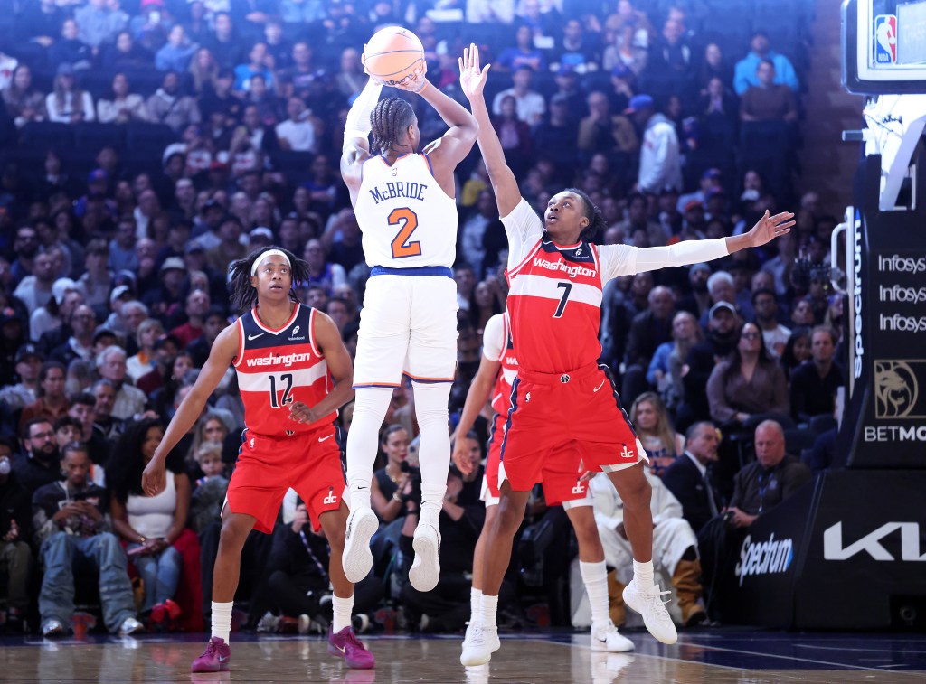 New York Knicks guard Miles McBride #2 puts up shot over Washington Wizard Bub Carrington.