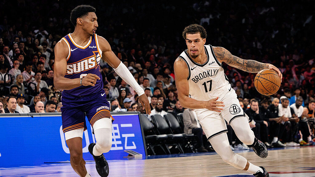 The Brooklyn Nets' Michaerl Porter Jr. #17 (R) dribbles during the NBA pre-season game between the ...