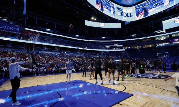 Players participate in a free-throw race during the annual Pick,...