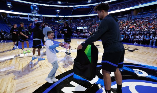 Players participate in a free-throw race during the annual Pick,...