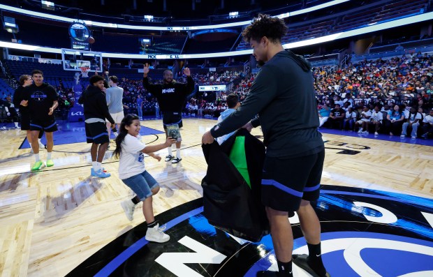 Players participate in a free-throw race during the annual Pick,...