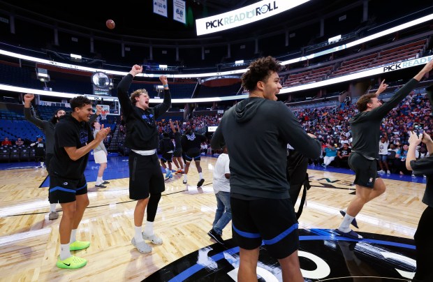 Players cheer after winning a round in a free-throw race...