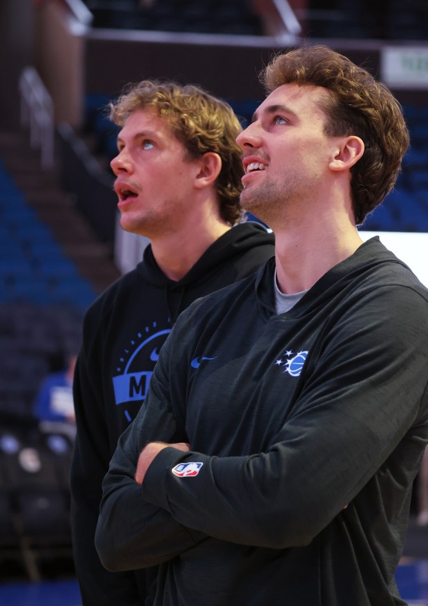Brothers Moritz and Franz Wagner look at the screens during...