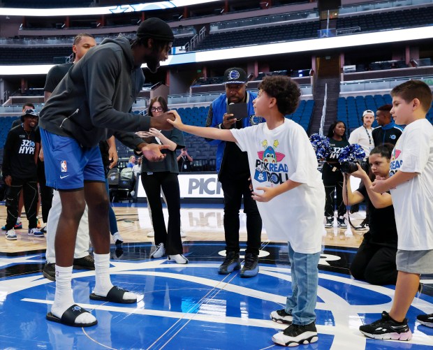 Jonathan Isaac plays rock paper scissors with a student during...