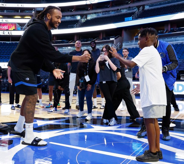 Wendell Carter Jr. plays rock paper scissors with a student...