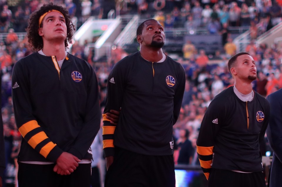 Playing 14 games in the 2016-17 regular season alongside Kevin Durant (C) and Steph Curry (R) before being waived, the Warriors gave Varejão (L) a championship ring for his role that yea