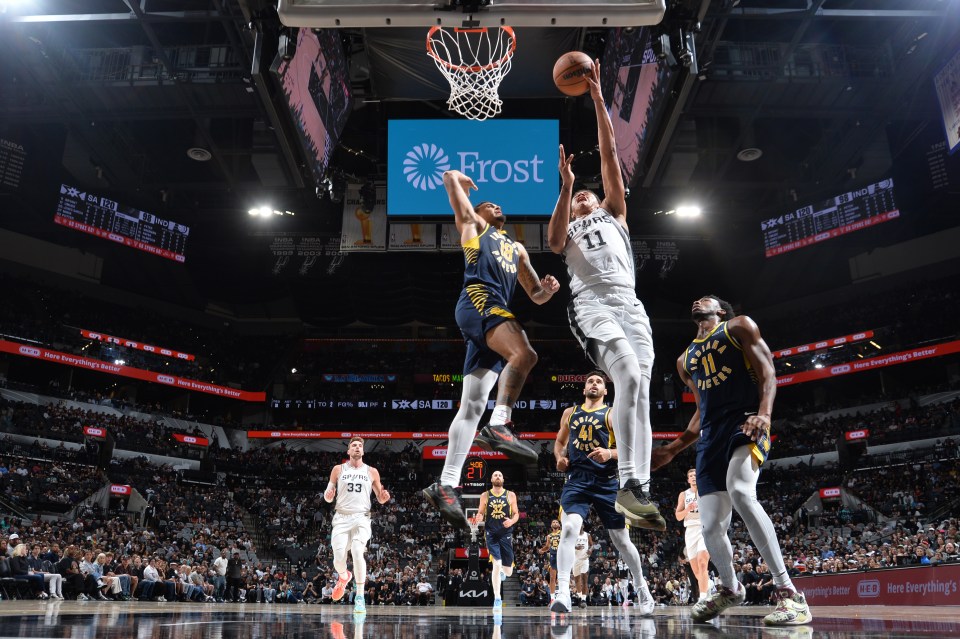 Carter Bryant #11 of the San Antonio Spurs goes to the basket during the game against the Indiana Pacers on October 17, 2025 at the Frost Bank Center