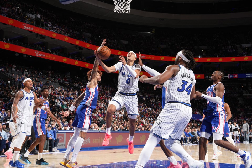 Anthony Black #0 of the Orlando Magic drives to the basket during the game against the Philadelphia 76ers