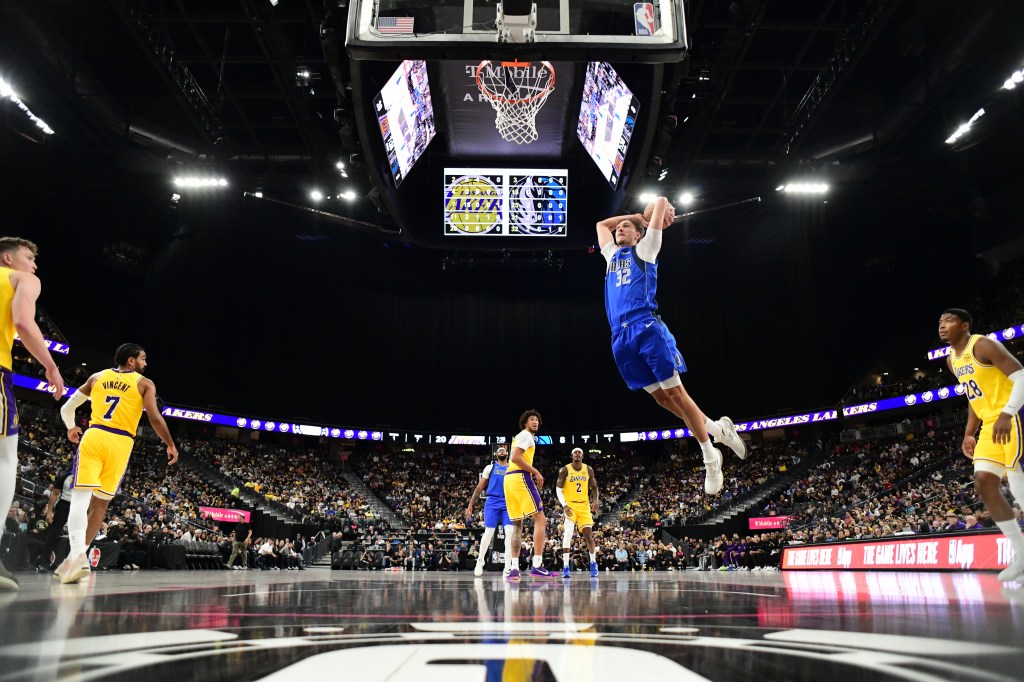 Dallas Mavericks player Cooper Flagg #32 dunks the ball during a game against the Los Angeles Lakers.
