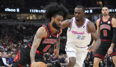 Apr 9, 2025; Chicago, Illinois, USA; Miami Heat forward Andrew Wiggins (22) defends Chicago Bulls guard Coby White (0) during the first quarter at United Center. Mandatory Credit: David Banks-Imagn Images