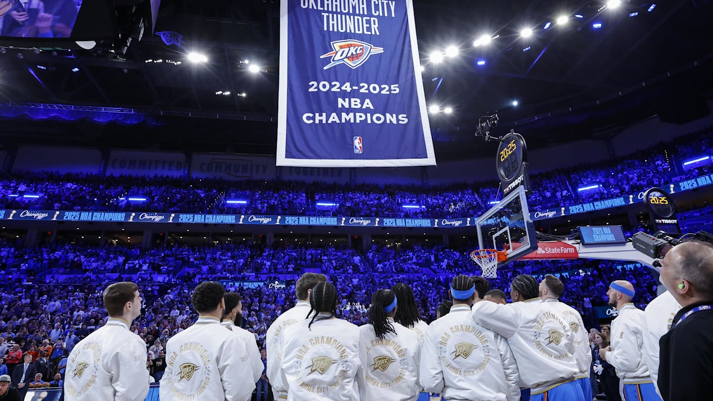 Oct 21, 2025; Oklahoma City, Oklahoma, USA; Oklahoma City Thunder team members watch as their NBA Championship banner rises before the start of a game against the Houston Rockets at Paycom Center. Mandatory Credit: Alonzo Adams-Imagn Images