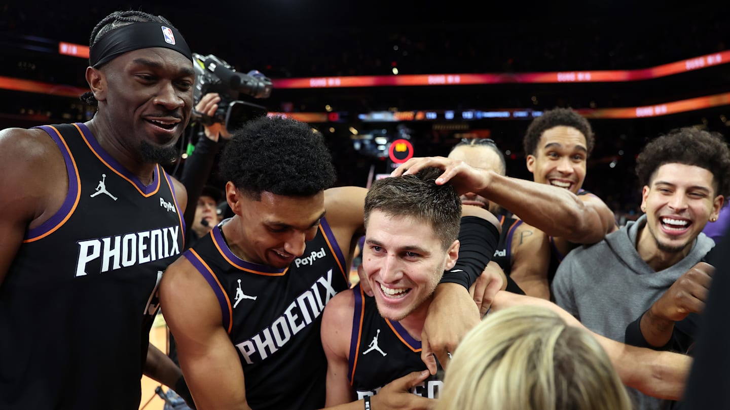 Phoenix Suns teammates celebrate with guard Collin Gillespie after he made the game-winning shot in an NBA Cup game against Minnesota.