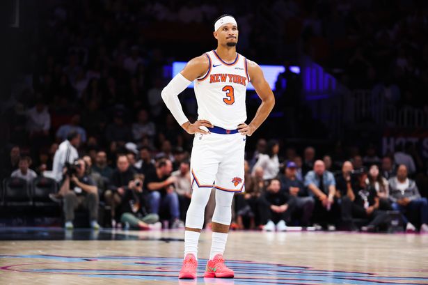 New York Knicks forward Josh Hart stands on the court with hands on hips