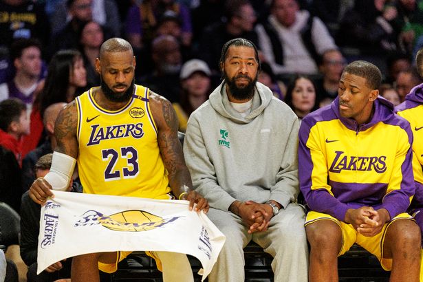 Lakers Markieff Morris sits between Los Angeles Lakers forward LeBron James (23) and Los Angeles Lakers center Trey Jemison III (55) during the game against the New York Knicks at Crypto.com Arena on March 6, 2025 in Los Angeles, California. He is listed out with an illness and didn't play