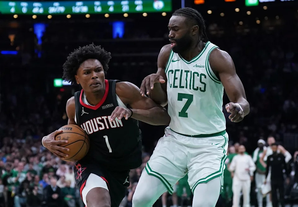 Jan 27, 2025; Boston, Massachusetts, USA; Houston Rockets forward Amen Thompson (1) drives the ball to the basket against Boston Celtics guard Jaylen Brown (7) in the last seconds of then game at TD Garden. Mandatory Credit: David Butler II-Imagn Images