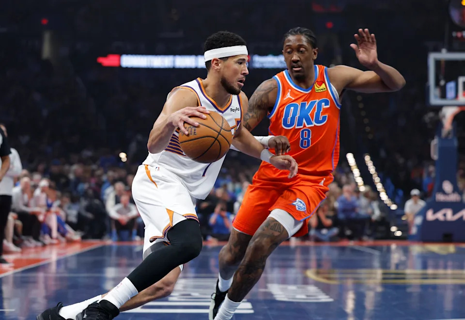 Nov 28, 2025; Oklahoma City, Oklahoma, USA; Phoenix Suns guard Devin Booker (1) drives to the basket past Oklahoma City Thunder guard Jalen Williams (8) during the first quarter at Paycom Center. Mandatory Credit: Alonzo Adams-Imagn Images
