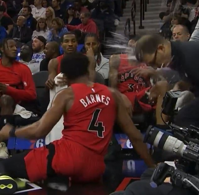 The bottle bounced up, exploded and then struck the staffer while he was wiping the court