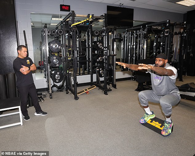 Lakers assistant Mike Mancias (left) was one of the staff members who was contacted