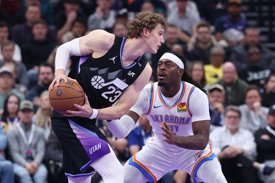 Nov 21, 2025; Salt Lake City, Utah, USA; Utah Jazz forward Lauri Markkanen (23) holds the ball as Oklahoma City Thunder guard Luguentz Dort (5) defends during the first half at Delta Center. Mandatory Credit: Rob Gray-Imagn Images