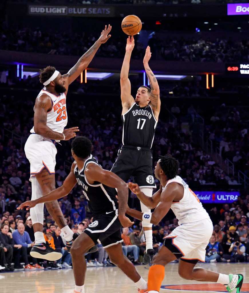 Michael Porter Jr. #17 of the Brooklyn Nets shoots as Mitchell Robinson #23 of the New York Knicks jumps to defend during the first half.