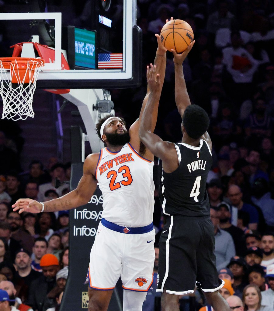 Mitchell Robinson blocking Drake Powell's shot during a game.