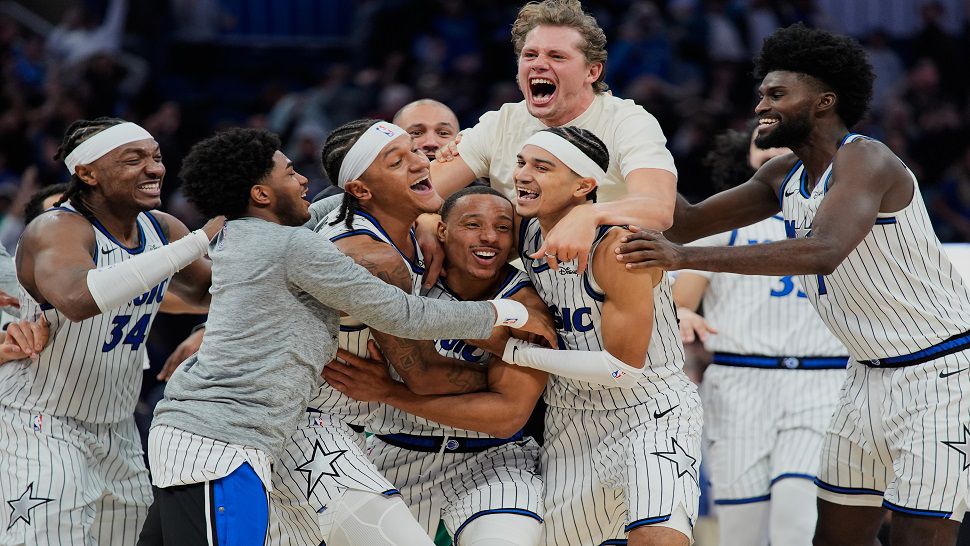Orlando Magic guard Desmond Bane, center, celebrates with teammates after making a game winning shot against the Portland Trail Blazers at the buzzer in an NBA basketball game, Monday, Nov. 10, 2025, in Orlando, Fla. (AP Photo/John Raoux)