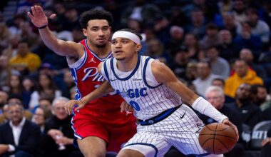 Orlando Magic's Anthony Black, right, drives to the basket against Philadelphia 76ers' Jared McCain, left, during the first half of an NBA Cup basketball game, Tuesday, Nov. 25, 2025, in Philadelphia. (AP Photo/Chris Szagola)
