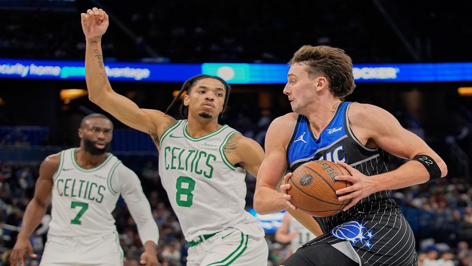 Orlando Magic forward Franz Wagner, right, drives past Boston Celtics forward Josh Minott (8) during the second half of an NBA Cup basketball game, Friday, Nov. 7, 2025, in Orlando, Fla. (AP Photo/John Raoux)