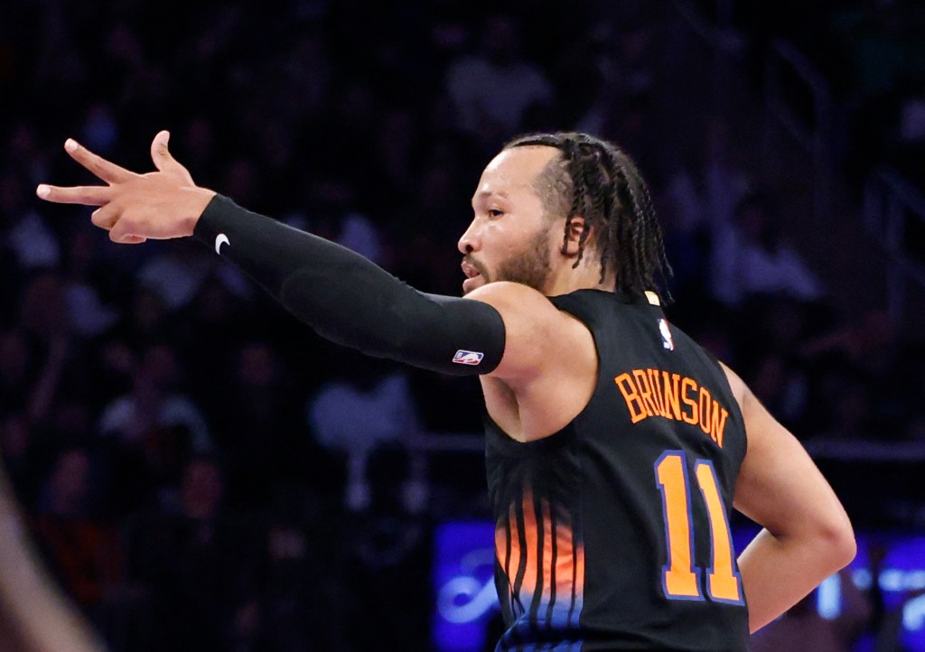 Jalen Brunson #11 of the New York Knicks reacts after hitting a three-point shot.