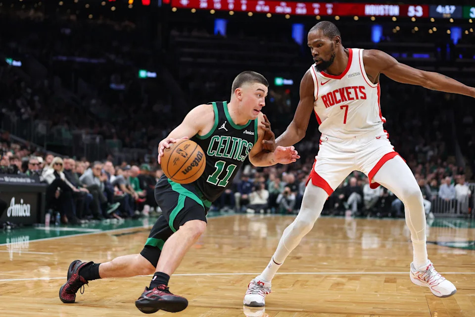 Nov 1, 2025; Boston, Massachusetts, USA; Boston Celtics guard Payton Pritchard (11) drives to the basket defended by Houston Rockets forward Kevin Durant (7) during the first half at TD Garden. Mandatory Credit: Paul Rutherford-Imagn Images