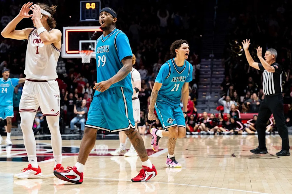 San Diego State guard Miles Byrd (21) reacts to hitting a game tying shot from half court during an NCAA Basketball game against Troy, Tuesday November 18, 2025 at Viejas Arena in San Diego, Calif.