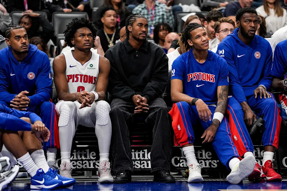 Detroit Pistons guard Jaden Ivey (23), center watches the game next to guard Ausar Thompson (9), left, and forward Bobi Klintman (34), right, during the second half against Boston Celtics at Little Caesars Arena in Detroit on Sunday, October 26, 2025.